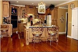 Spacious kitchen with hardwoods, maple mocha-glazed Tobbit cabinets, granite a