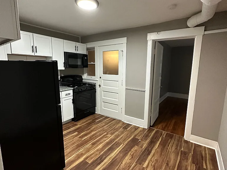 Kitchen with grey walls and white trim at University Court.