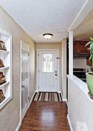 Raised panel entry door with decorative leaded glass inset.