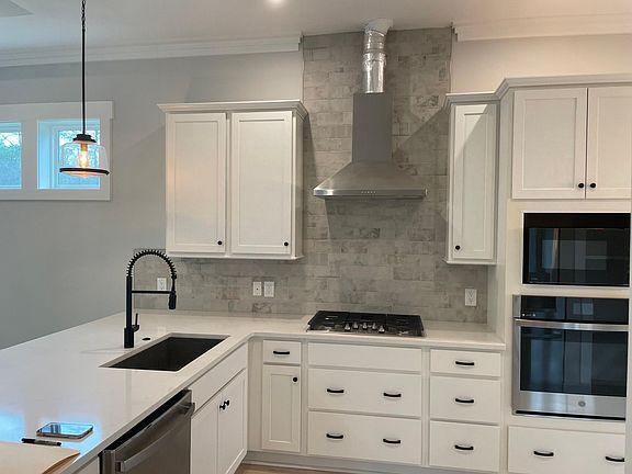 Large Kitchen with plenty of storage opens to the great room/dining area. Note, larger covered vent as seen in prior photo has replaced the vent pictured here