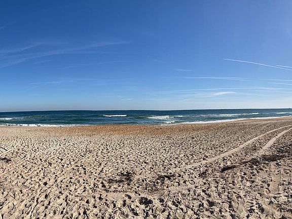 Experience the beauty of beachside living. This golfer's paradise estate is only a short stroll to the serene Neptune beach approach.