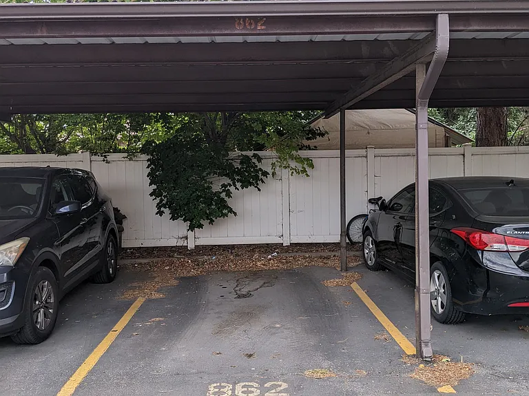 covered parking spot; additional uncovered parking spot in front of unit door