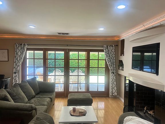 French door leads to back yard with covered patio for shade