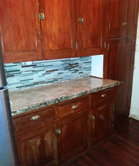 Original-wood1913 cabinets match the new mission-style cabinet upgrades on the opposite wall, providing ample storage for your needs.