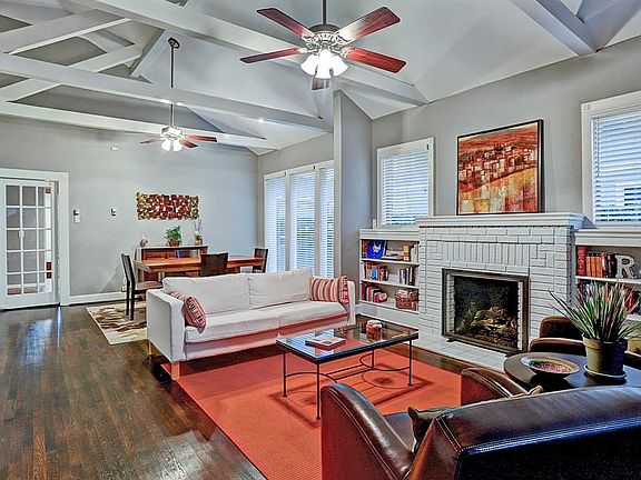 WOW! This room is the crown jewel. Open beam vaulted ceiling, gorgeous wood floor, ton of natural light, the fireplace and the s