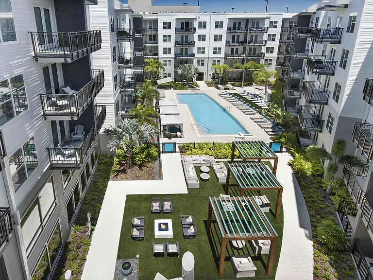 Aerial View of Pool Surrounded by Cabanas, Pergolas, and Lounge Spaces