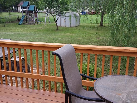 View of yard, play set, shed