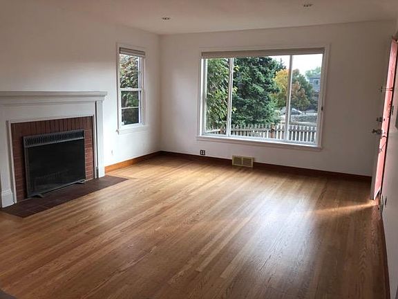 Very large living room - picture window on south side, two east-facing windows on each side of fireplace