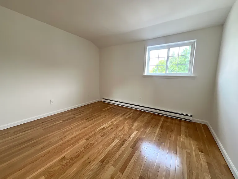 Bedroom with hardwood floors and natural lighting