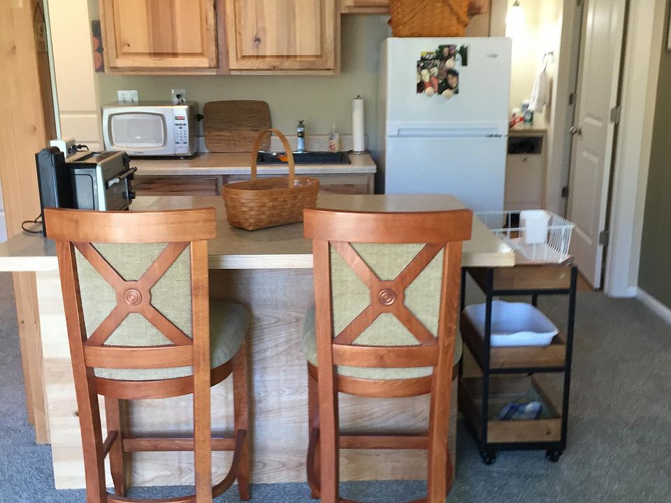 Kitchen and Island with bathroom entrance on the right hand side of the photo