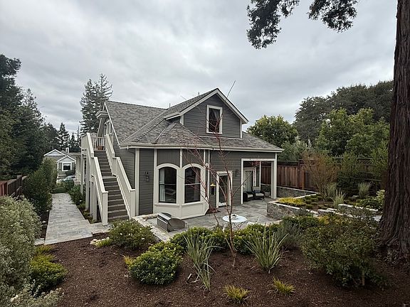 Rear view of the house and the stairs leading to the upstairs cottage.