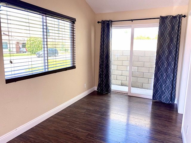 Living room. Lots of windows. Side sliding glass door exits to small side yard.