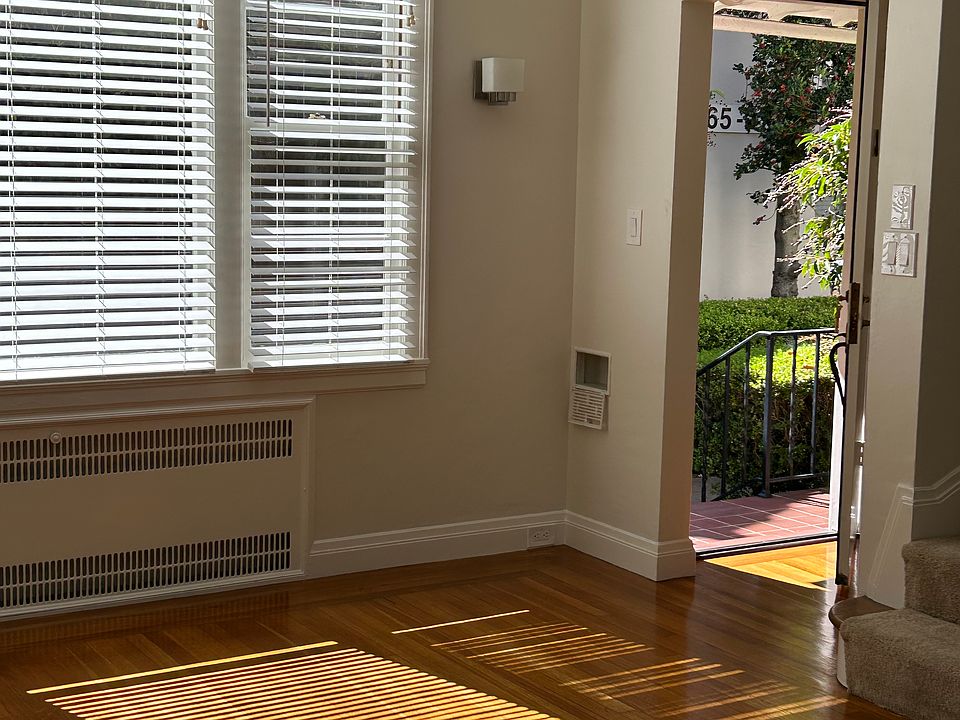 Living room with beautiful hardwood. Looking out front door.