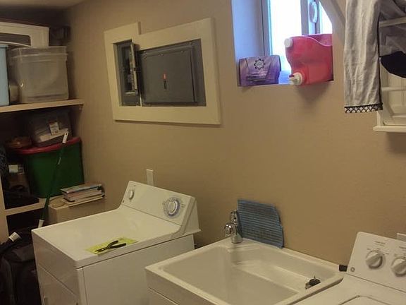Inside laundry with built in shelves - brand new washer and dryer