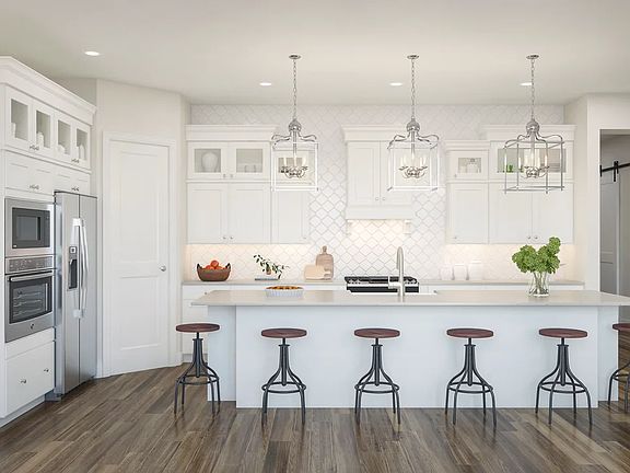 Kitchen with pendant lighting and upper glass cabinets