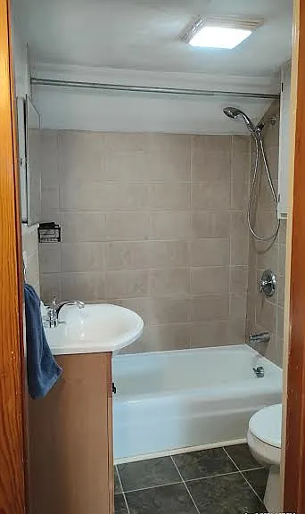Bath entrance, exhaust fan and light is centered in freshly painted ceiling.