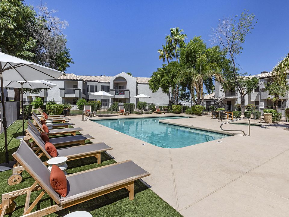 Chic poolside retreat with lounge chairs and umbrellas, right outside our building