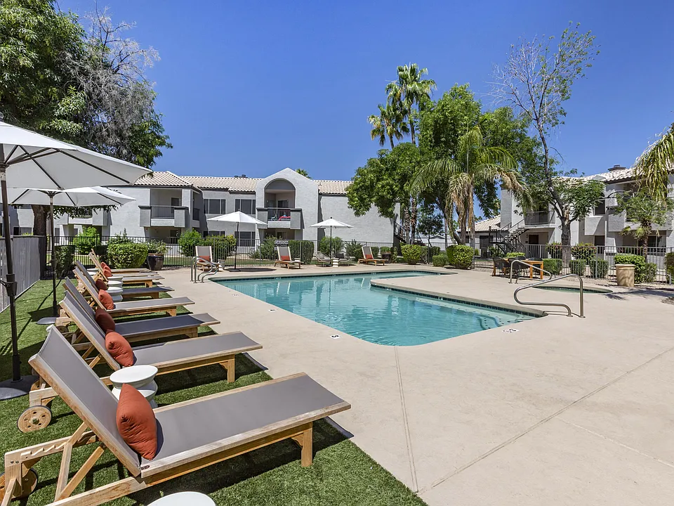 Chic poolside retreat with lounge chairs and umbrellas, right outside our building