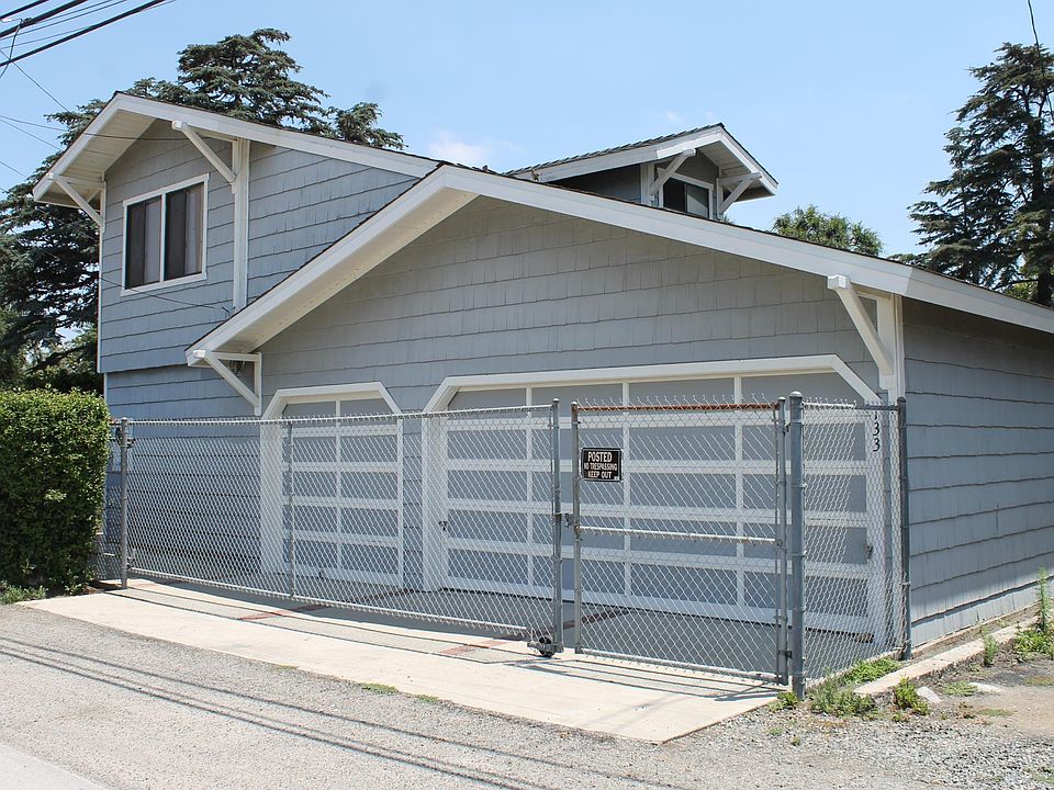 Alley entrance with secure gate. Single car garage on left. The 2-car garage is for the front house.