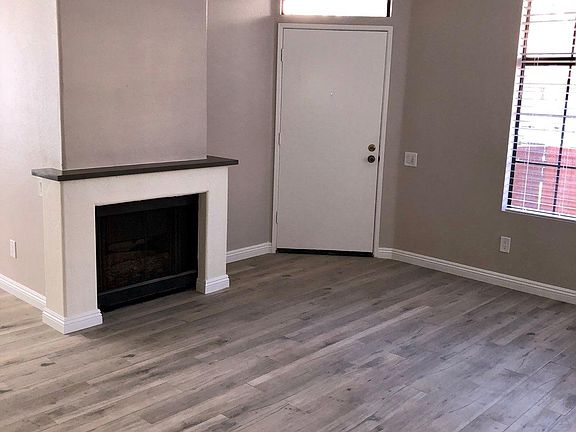 Living room with gas fireplace and ceiling fan