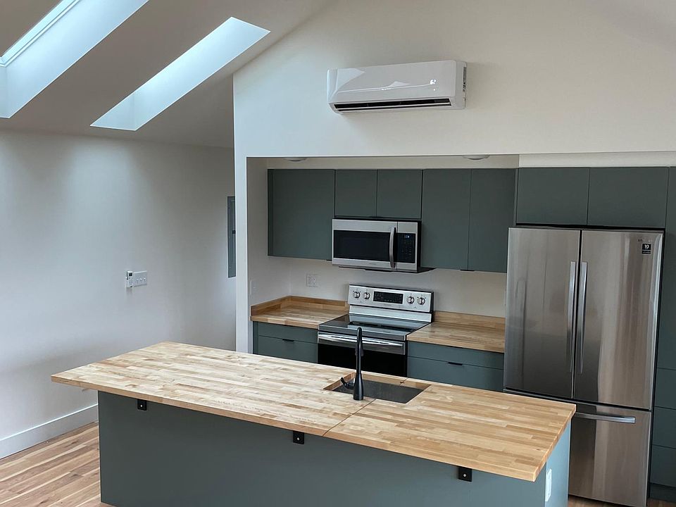 Large open kitchen. Butcher block island has seating for five.