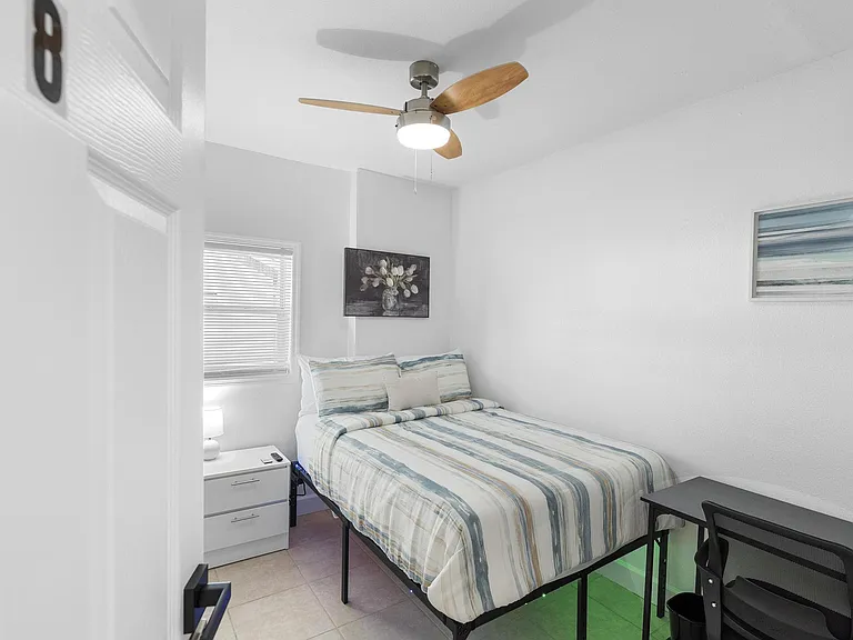 Clean, modern room with TV & desk setup ideal for professionals in Sanford, FL