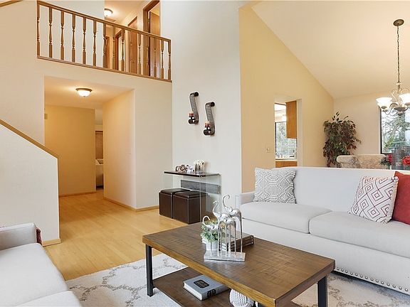You are going to fall in love with the dramatic, two story vaulted ceiling in the formal living room. Timeless wood balusters that pass through light from the second level. 