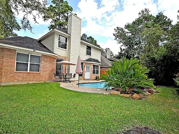 Backyard Lush and grassy yard with Refreshing Personal Swimming Pool