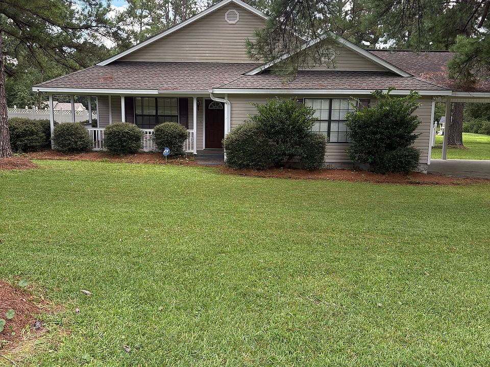 This charming 4-bedroom, 2-bathroom home is tucked away in a quiet neighborhood surrounded by mature trees. With its inviting wrap-around front porch and large screened-in back porch, this property offers plenty of space to relax indoors and out.