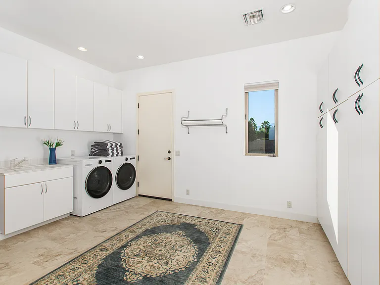 SPACIOUS LAUNDRY ROOM IN MAIN HOUSE. DOOR IN THIS PHOTO LEADS OUTSIDE TO THE GUEST HOUSE.