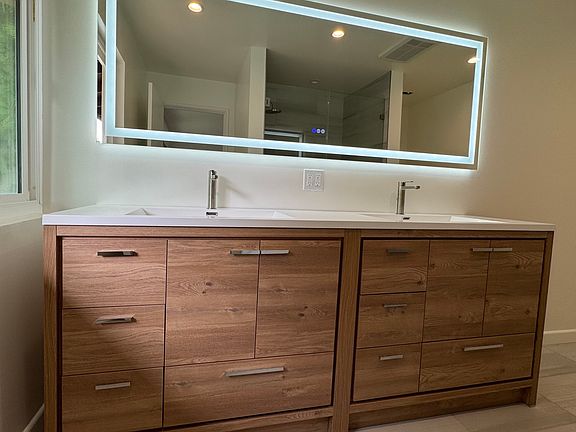 The roomy remodeled master en-suite has dual vanities and large shower.