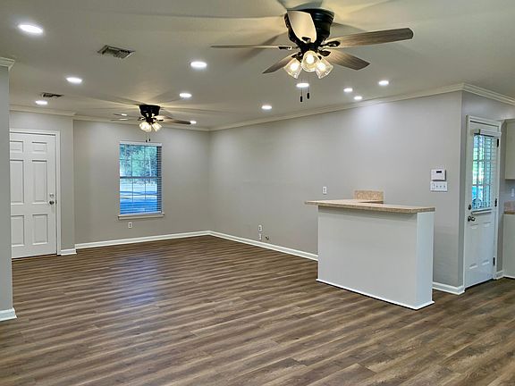 Living room with bar. Wooden blinds through out.