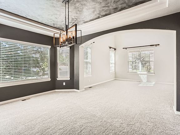 Formal dining room looking into formal living room by front door.