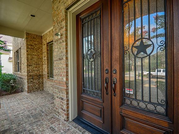 Double doors with a front patio sitting area.