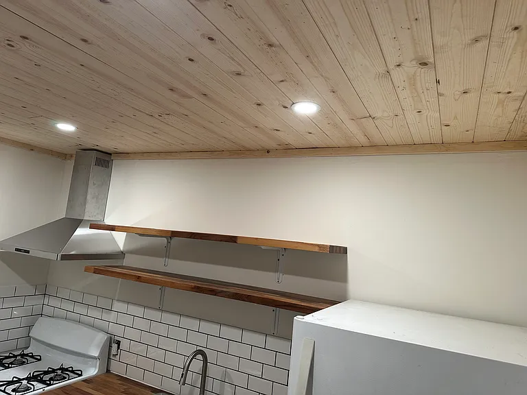 New kitchen ceiling, lighting and kitchen stove hood, along with new shelving