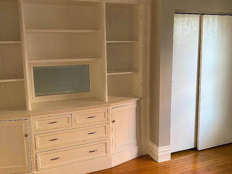 Bedroom with built-in storage and closet