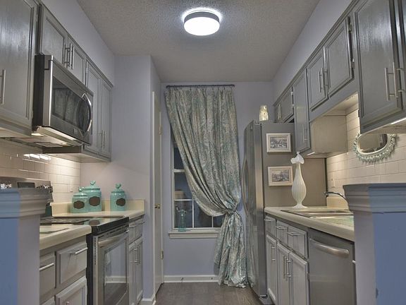Recently updated kitchen with stainless steel appliances, subway tile backsplash and under-counter lighting