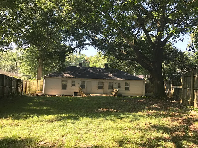 View of duplex from 8' fenced yard. Fence covers both sides of property as well.