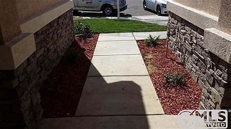 Front Entry with Flowering Plants and Automatic Sprinkler System.