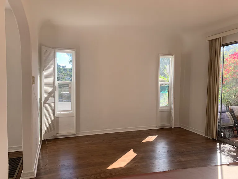 Living room with slider to private patio, hardwood floors