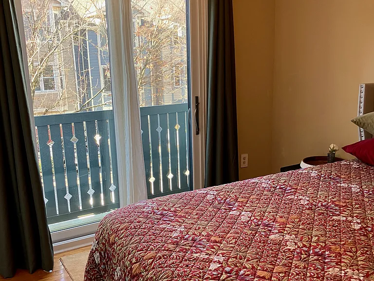 2nd floor bedroom with Juliet balcony and hardwood floors.