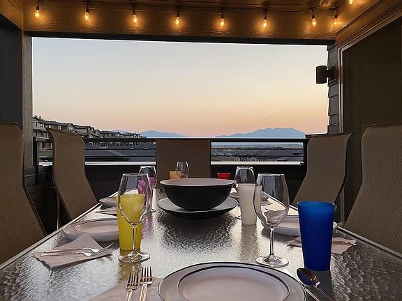Rooftop looking west. Table for 8 with dinnerware.