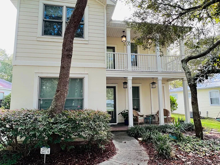 The house has three porches with the back porch being screened in