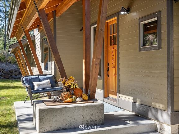The covered entry welcomes you with architectural timbers and beams, and beautiful solid wood door.