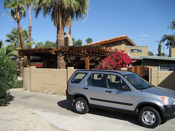 Parking driveway is 2 lanes with Private garage at the end... Behind the car is the Gate leading to a courtyard and entry to the back home