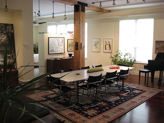 high ceilings, full windows, track lighting make for a spacious and light room