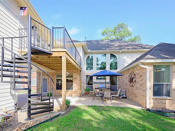 The rear patio and the spiral staircase from the second floor deck.
