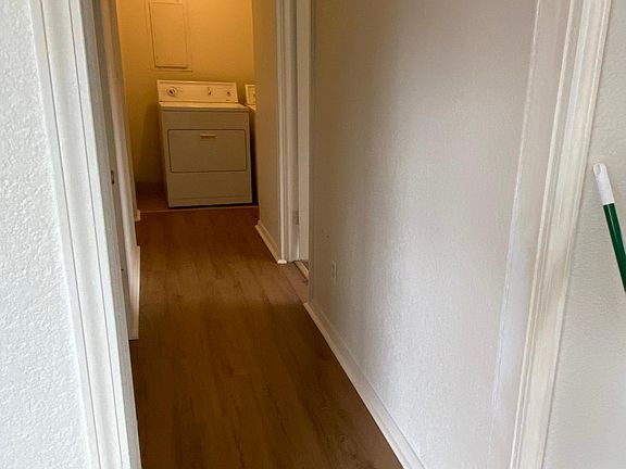 hallway with washer/dryer at end