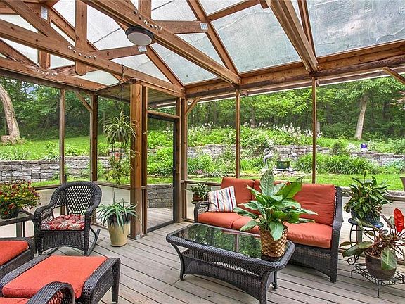 Find your happy place here.  Peace & serenity & privacy on the screened-in porch overlooking the gorgeous yard & treed area.  Easy care plantings & perennials.
