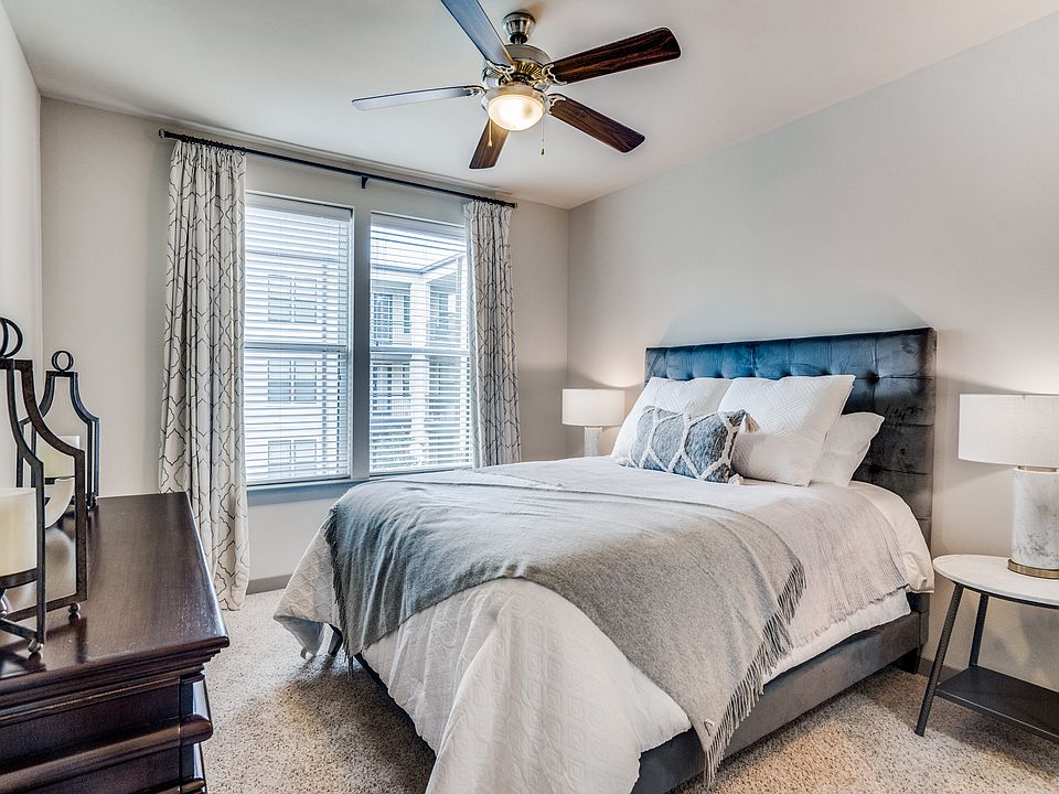 large bedroom with queen size bed and natural light